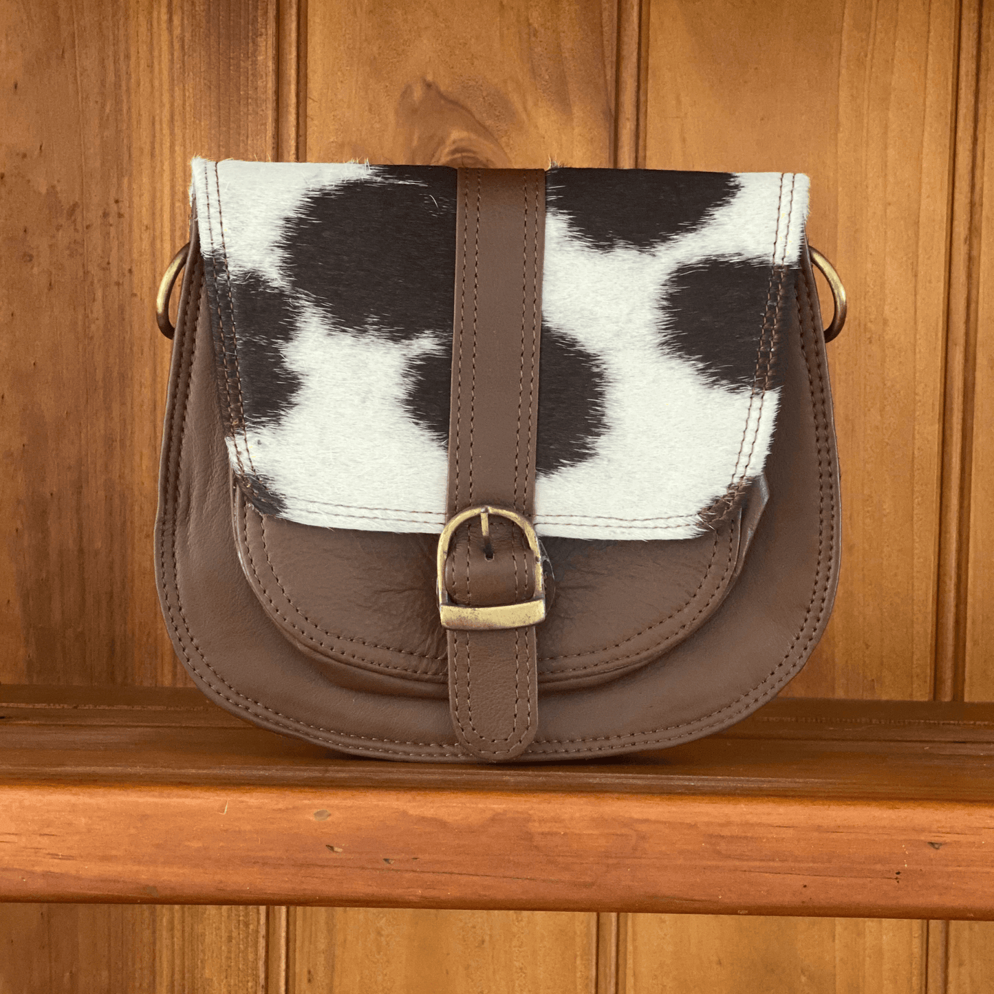 Women’s leather shoulder bag with clip-on strap and compartments