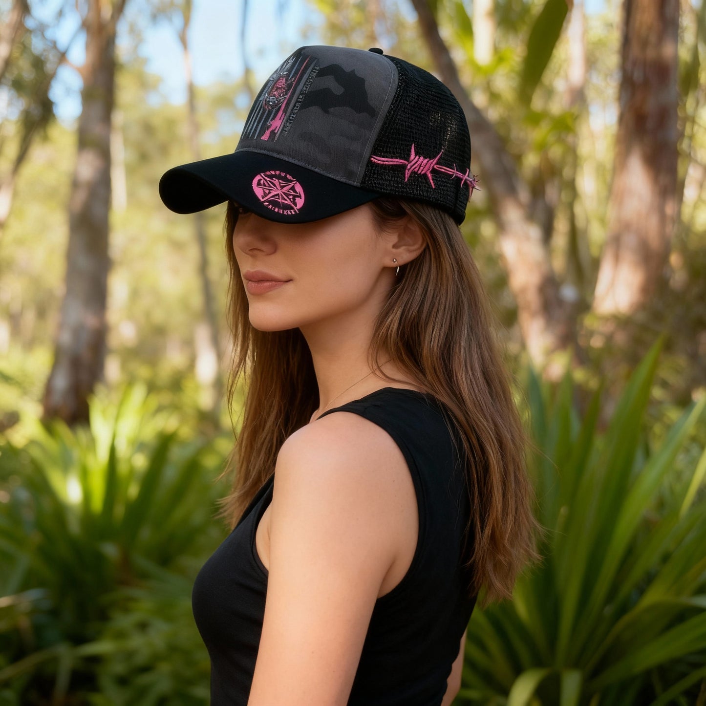Pink HUNT EAT SLEEP REPEAT logo printed on camo trucker hat