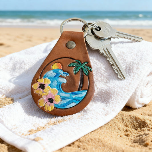 Beach keychain attached to a backpack zipper in coastal setting