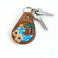 Close-up detail of ocean charm beach keychain with silver ring